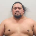 Sumo wrestler with long hair and muscular build.