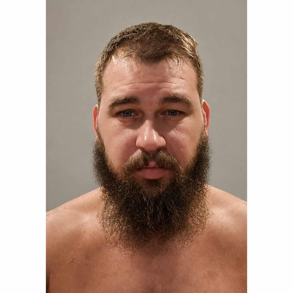 Portrait of a man with a full beard and short hair.