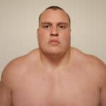 Close-up of a sumo wrestler's face and shoulders.