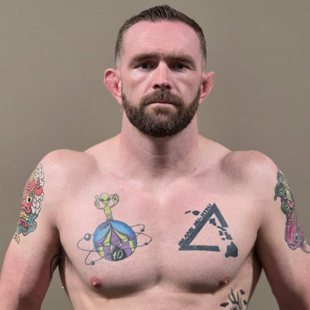 Sumo wrestler Matthew Cox with tattoos on his chest and arms.