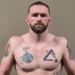 Sumo wrestler Matthew Cox with tattoos on his chest and arms.
